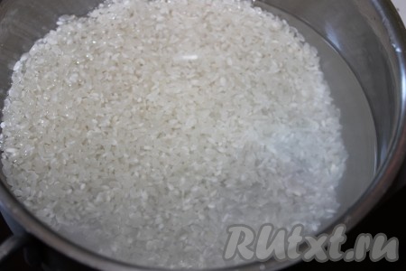 Переложить промытый рис в кастрюлю с толстым дном, влить два стакана холодной  воды. Довести до кипения, затем уменьшить огонь и варить  примерно 10 минут. За это время рис впитает необходимое количество воды  и слегка разбухнет.
