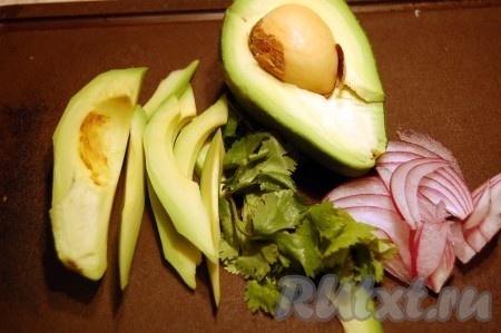 Очистить и нарезать длинными дольками авокадо, лук репчатый и зелень.