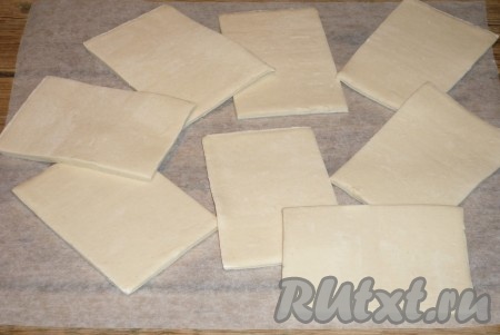 Если слоеное тесто замороженное, то его нужно разморозить (тесто должно стать мягким). Разрезать тесто на прямоугольники одинакового размера (у меня получилось 8 штук). 
